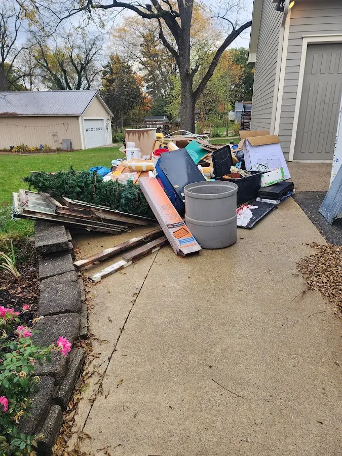 Dumpster being loaded with debris for 12 Yard Dumpster Rental in Breaux Bridge